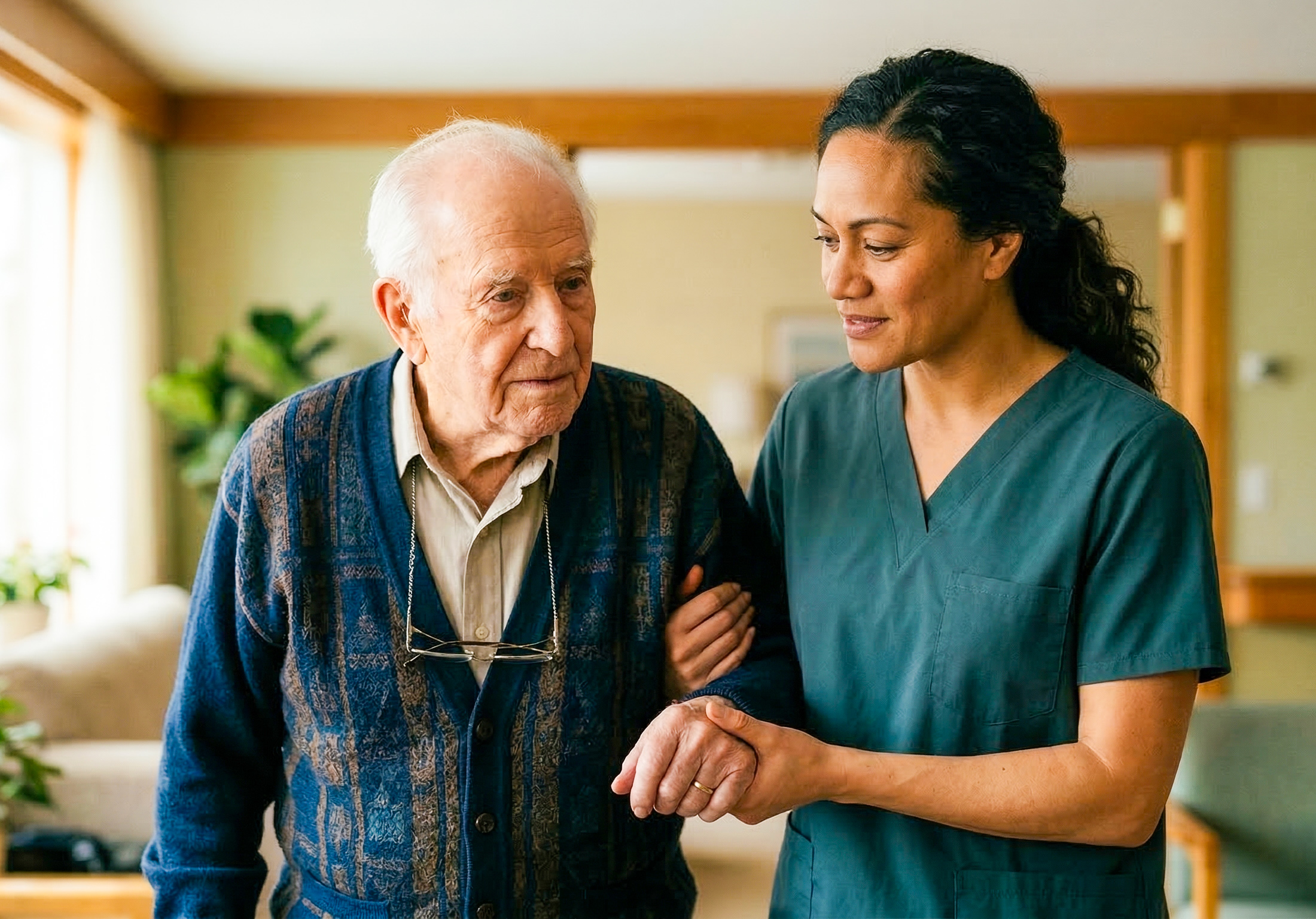 Caregiver assisting elderly man at home